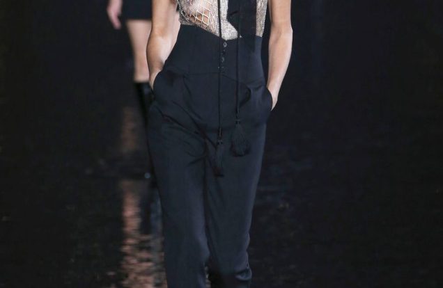 sexiest-womenswear designer of the year-YSL-2019-photo of runway model wearing hat, see through top, high waisted pants, long bow and lizard skin boots