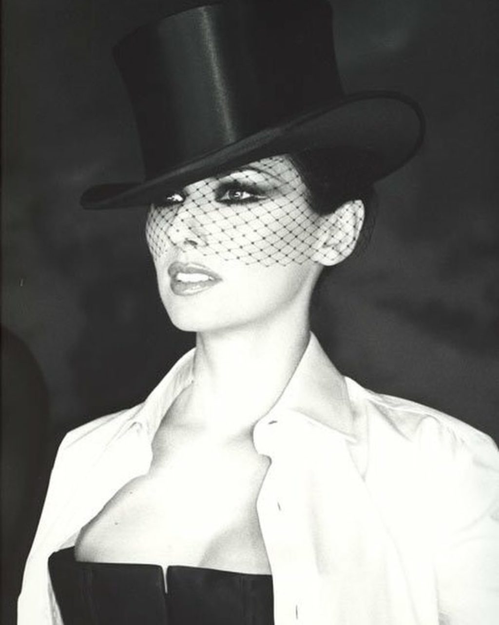 Shania Twain Wearing Top Hat, White Shirt and Sexy Black Dress by Marc Bouwer