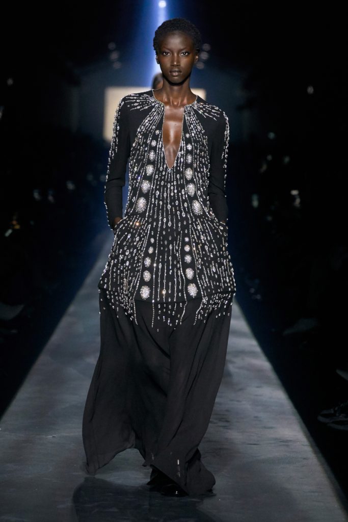 GIVENCHY COLLECTION FALL 2019 RUNWAY AFRICAN FEMALE MODEL WEARING SEXY BLACK AND WHITE BEADED DRESS WITH PLUNGING NECKLINE