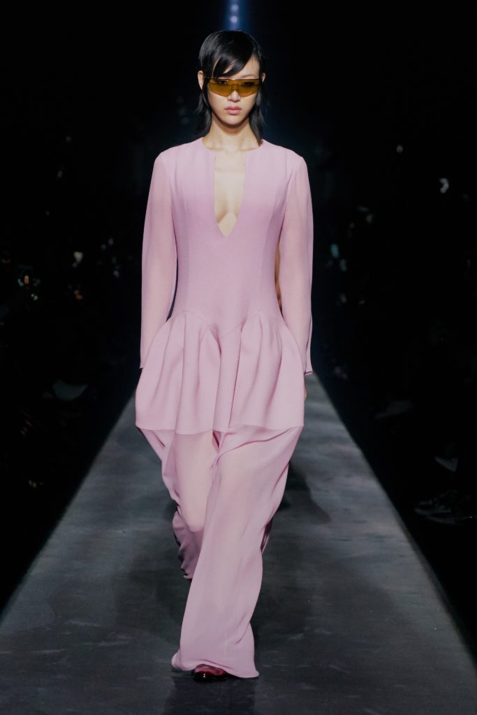 GIVENCHY COLLECTION FALL 2019 RUNWAY ASIAN FEMALE MODEL WEARING YELLOW TINTED SHADES AND SEXY PINK ONESUIT WITH PLUNGING NECKLINE