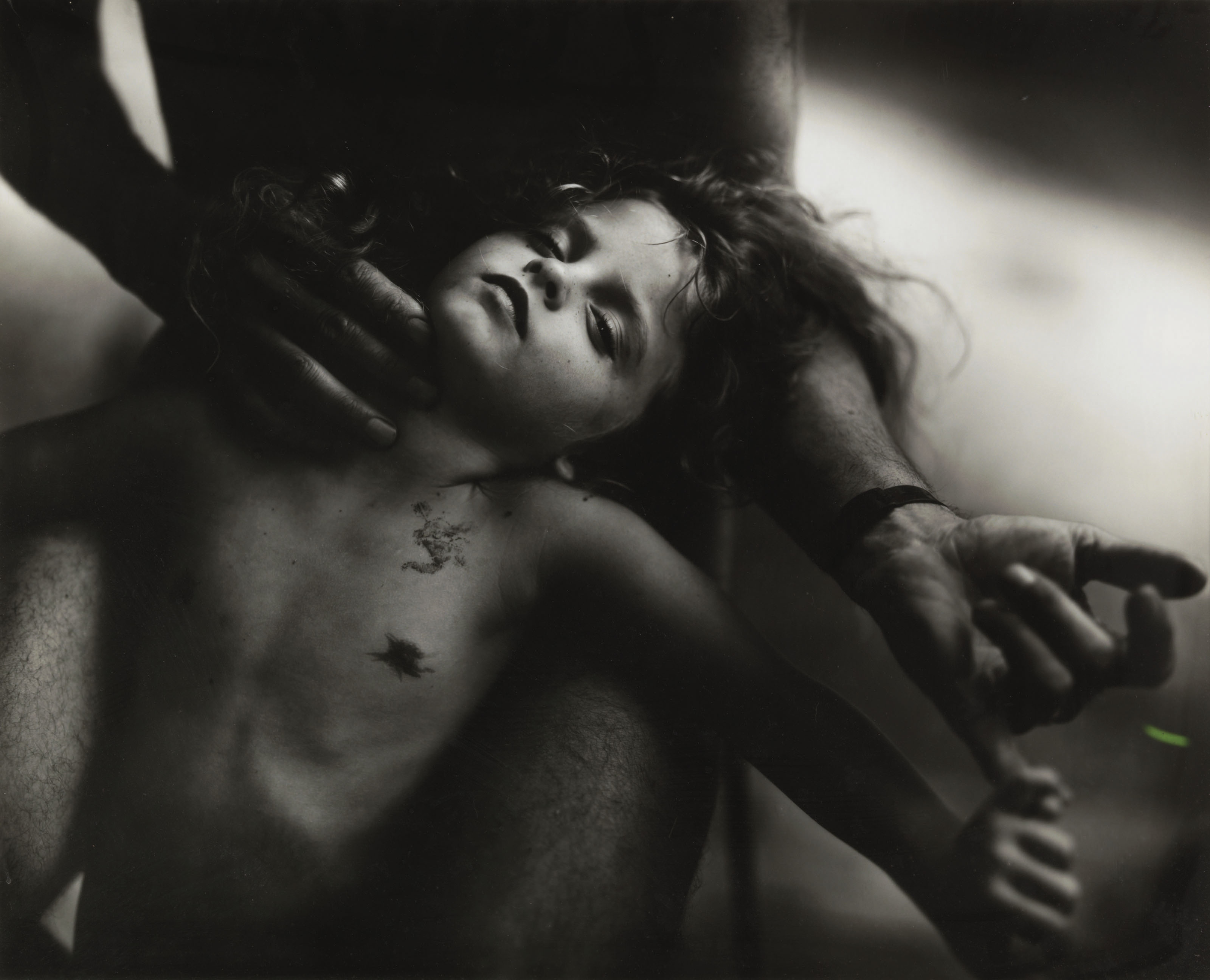 sally mann photograph of a child sleeping in a parent's lap