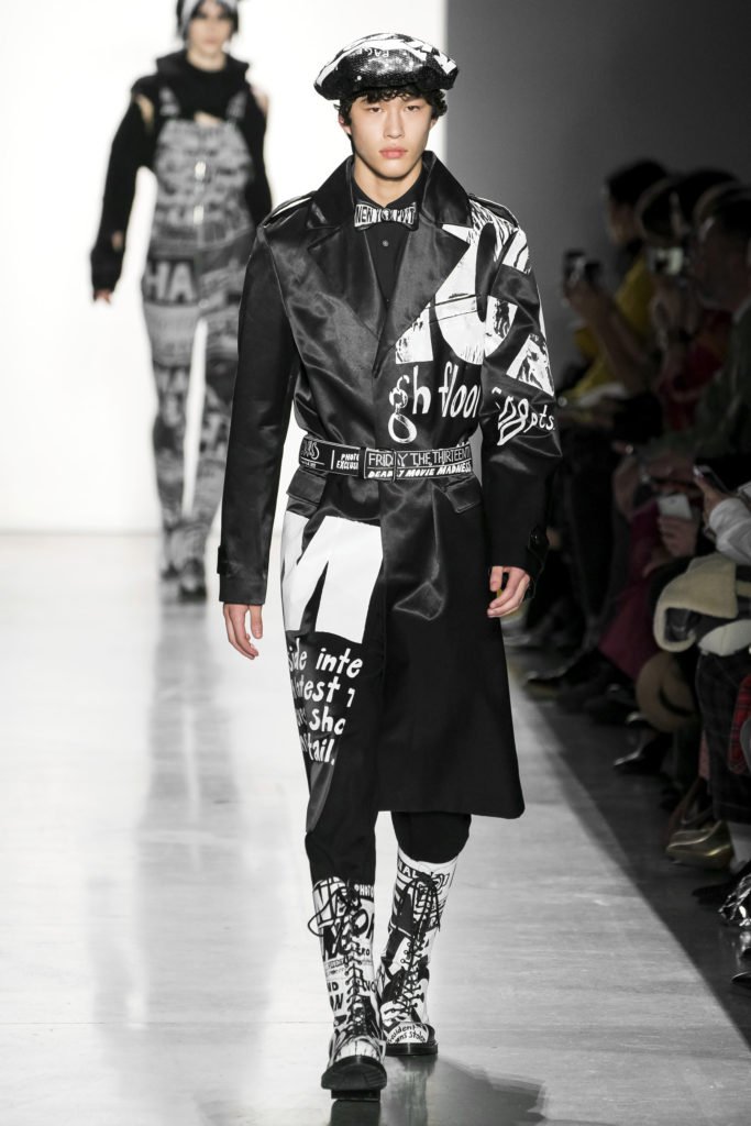Jeremy Scott Runway Model Wearing a leather printed beret, coat and combat boots