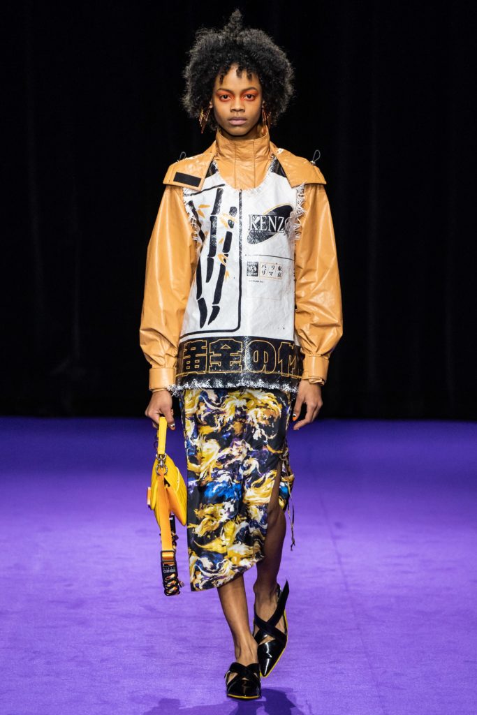 Kenzo Model Wearing printed leather jacket with yellow sleeves and a border with Chinese letters