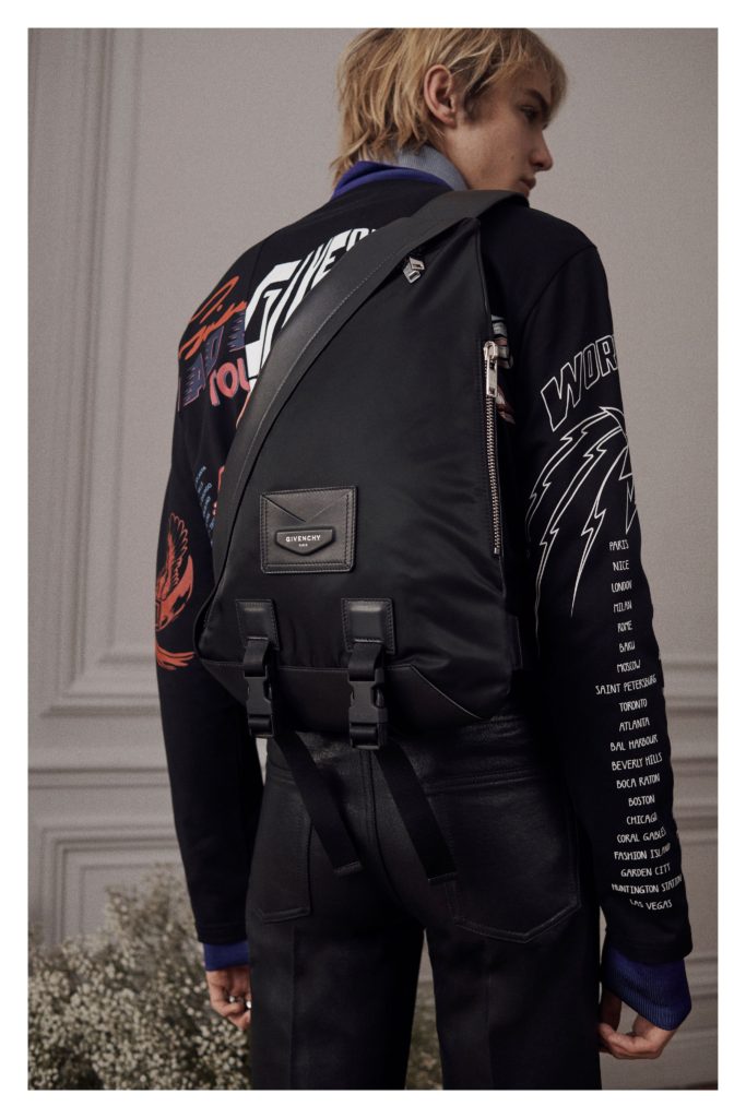 givenchy-menswear-paris-fall-19-back of jacket with list of cities written on a sleeve and other words printed on the back