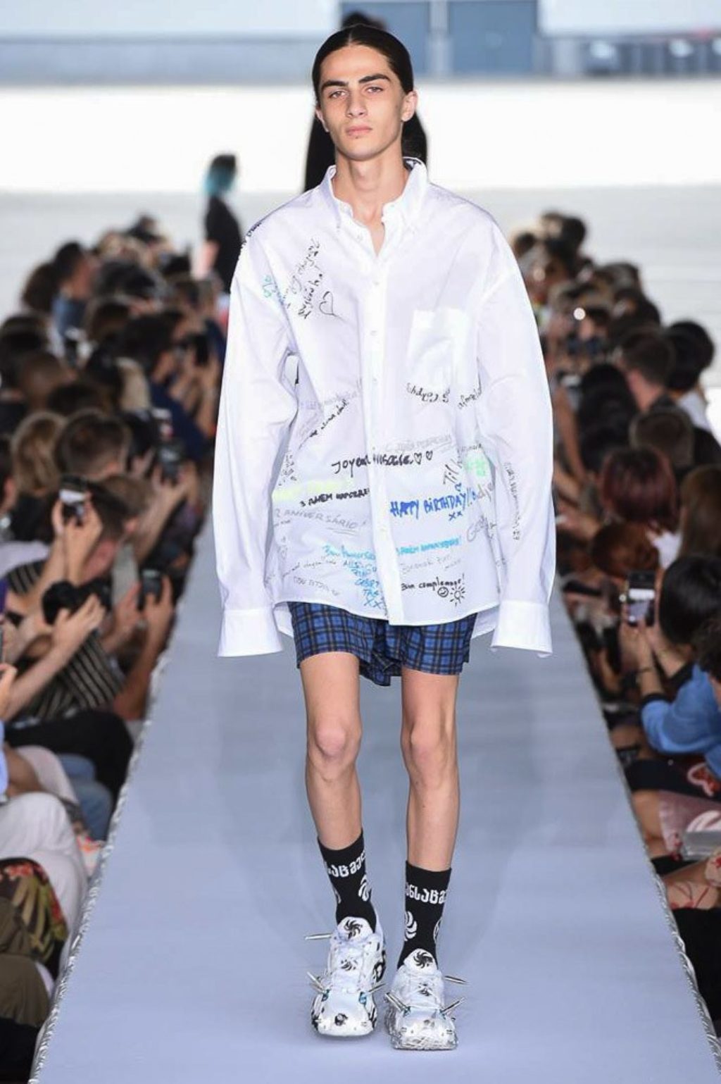 vetements male runway model wearing white shirt with handwritten names and notes