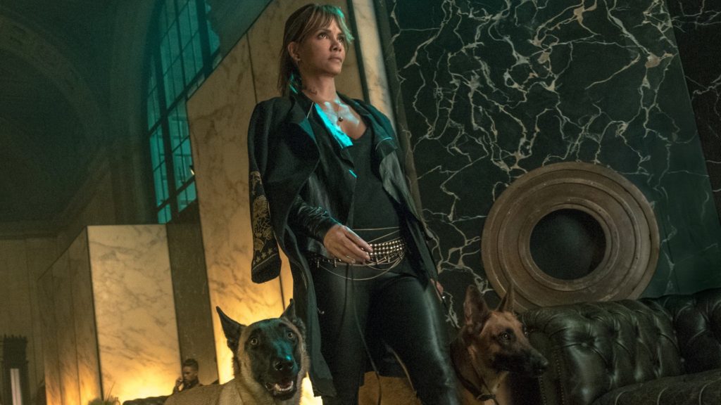 Halle Berry in leather walking with fierce dog