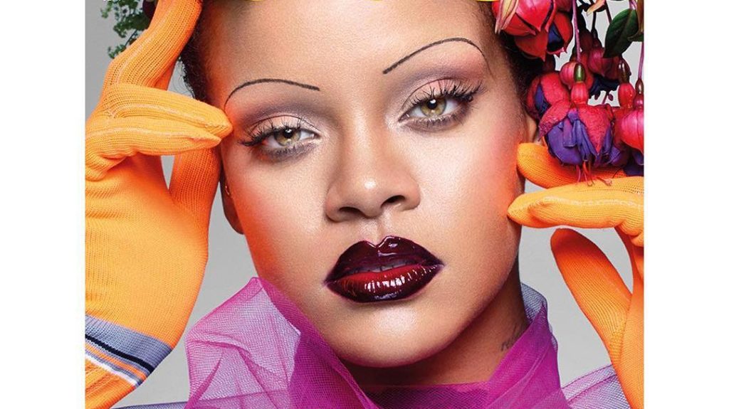 Rhianna Face wearing red lipstick and orange gloves