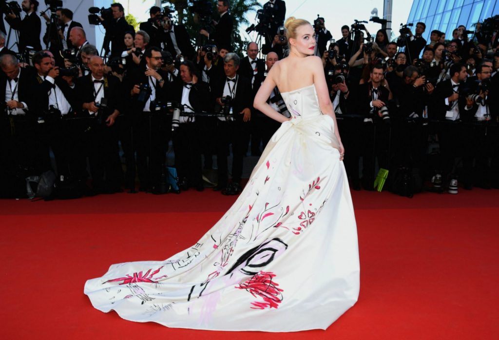 elle fanning in vivienne westwood dress with long train on the red carpet at Cannes