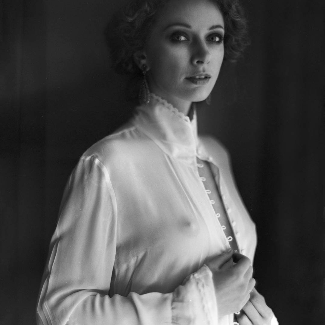 portrait of a woman in a sheer white blouse