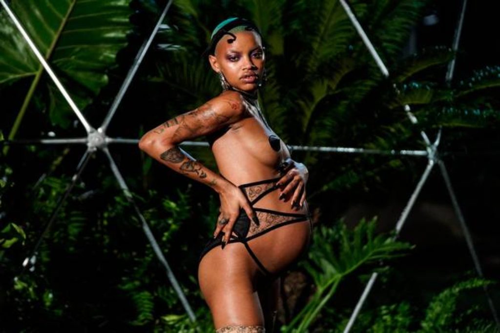 Rhianna-Model-Muse-Slick-Woods-Posing-Pregnant-against-green-flora