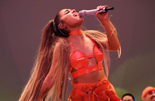 Ariana-Grande-on stage-wearing a red leather bustier-red mini skirt-summer 2019 and red thigh boots