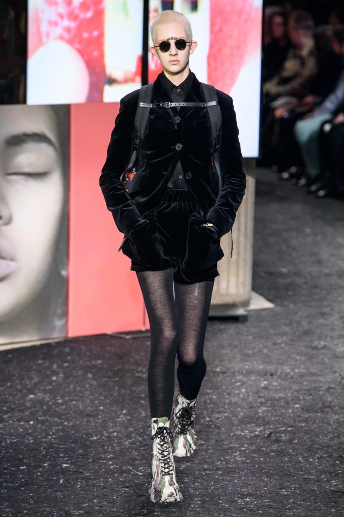 MIU MIU Fall 2019 Runway Model Wearing Black Velvet cropped jacket and black velvet shorts and camoflauge ankle boots with black laces