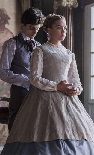 Timothee Chalamet as Laurie and Florence Pugh as Amy Marsh in a scene where Laurie is tying the back of Amys dress