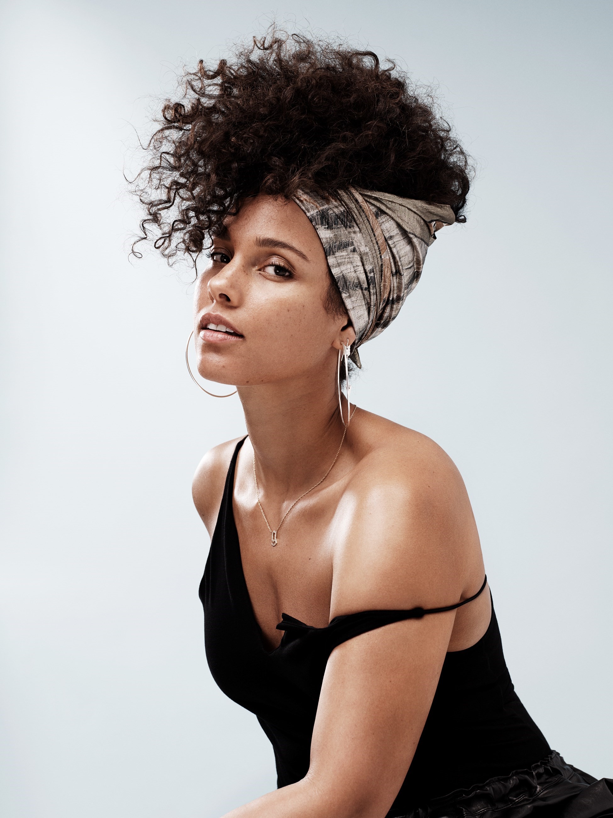 Alicia Keys looking sexy wearing a black tank-big hoops and head wrap