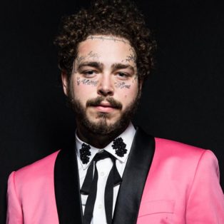 Post Malone in Pink Tuxedo with Black lapels-white shirt and skinny black cowboy tie