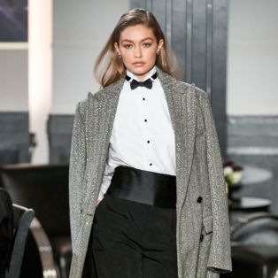 Model Gigi Hadid in Ralph Lauren Runway NY Fashion Week 2019 Wearing Sequined Tweed Black and White Coat-Tuxedo Shirt- Bow Tie-Cumberband and Black Pants