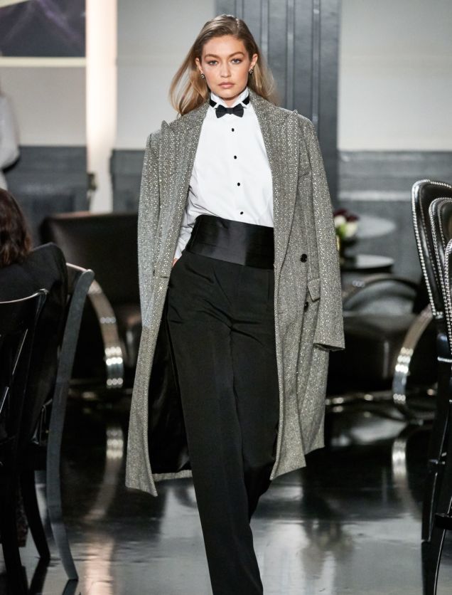 Model Gigi Hadid in Ralph Lauren Runway NY Fashion Week 2019 Wearing Sequined Tweed Black and White Coat-Tuxedo Shirt- Bow Tie-Cumberband and Black Pants
