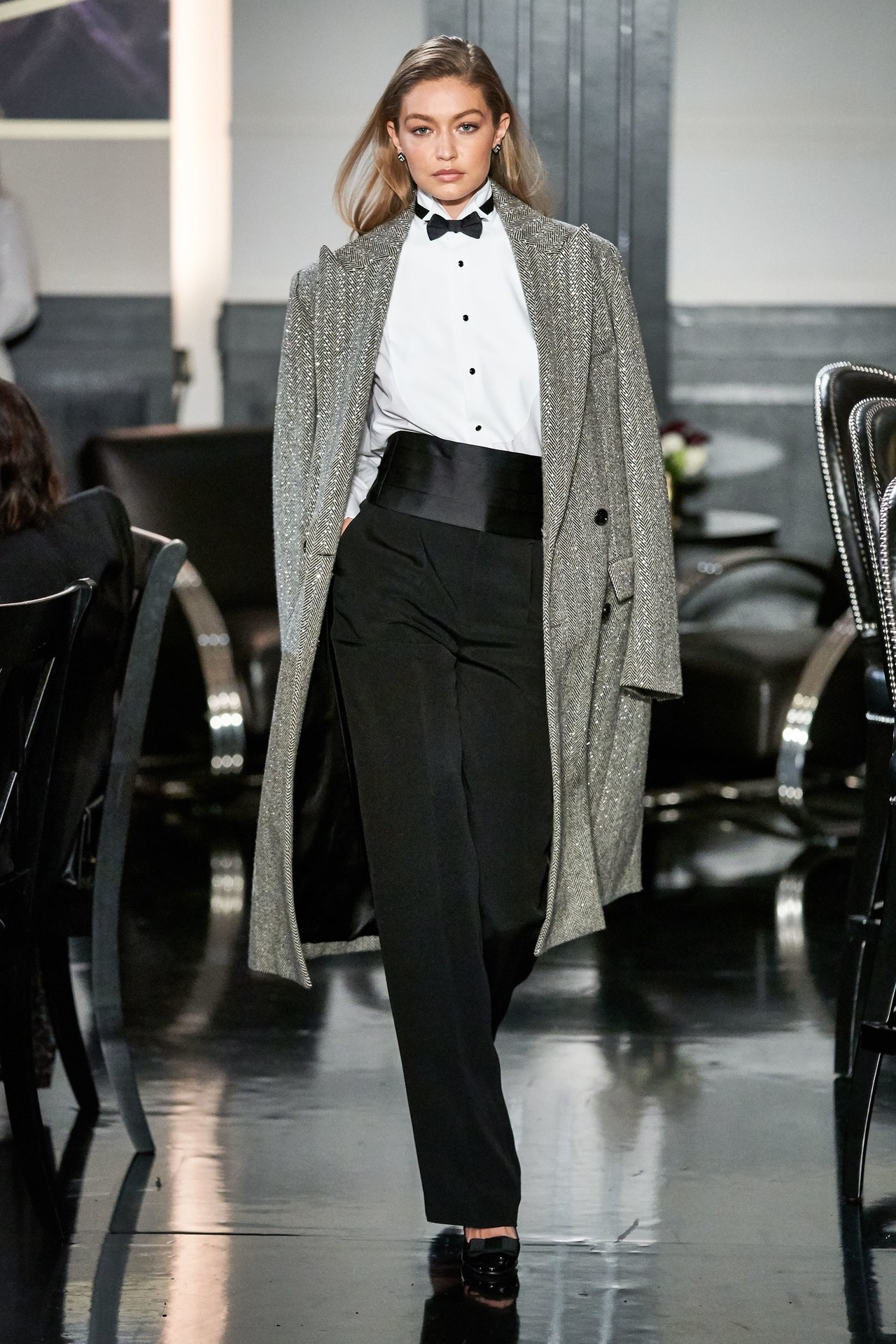 Model Gigi Hadid in Ralph Lauren Runway NY Fashion Week 2019 Wearing Sequined Tweed Black and White Coat-Tuxedo Shirt- Bow Tie-Cumberband and Black Pants