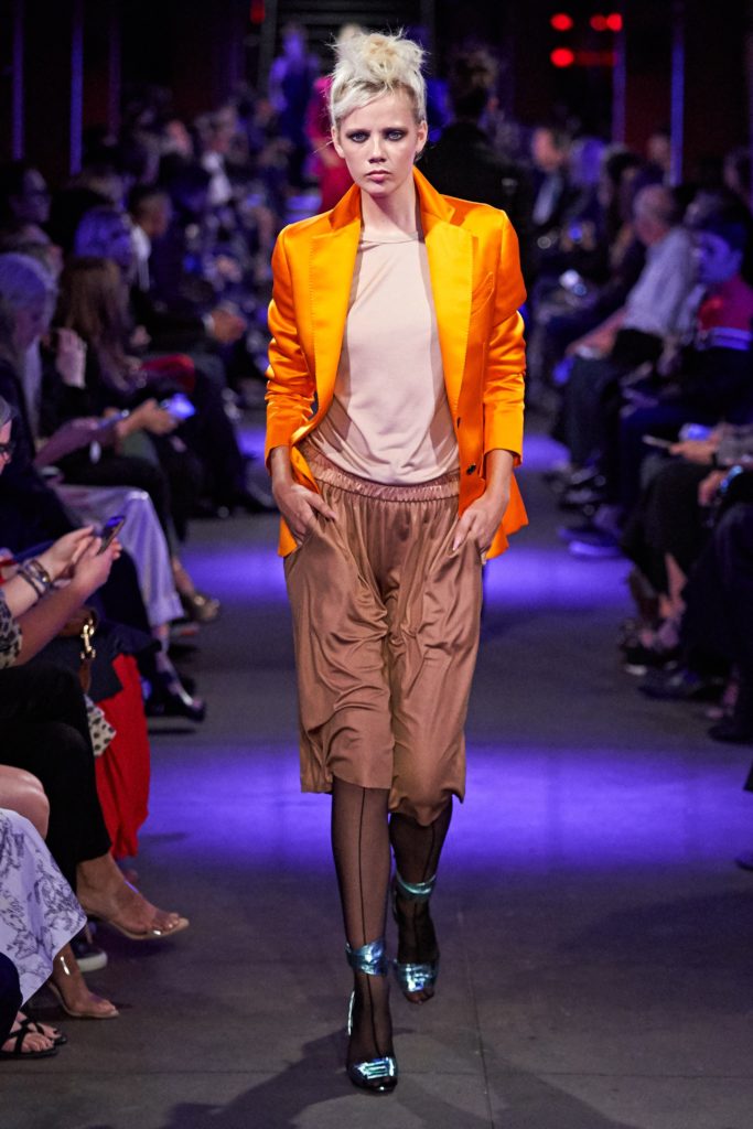Tom Ford Runway SS 2020 Model Wearing a Bright Orange Blazer and Blue metalic high heel platforms