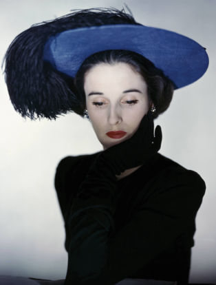 Miss Cushing Mortimer wearing a blue hat with plumes of feathers. (Photo by Erwin Blumenfeld/Condé Nast via Getty Images)
