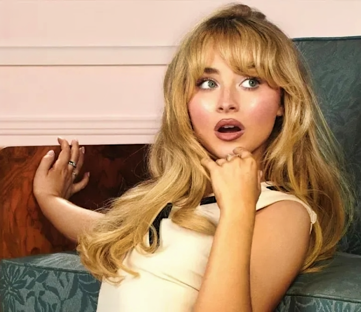 Sabrina Carpenter sitting in chair