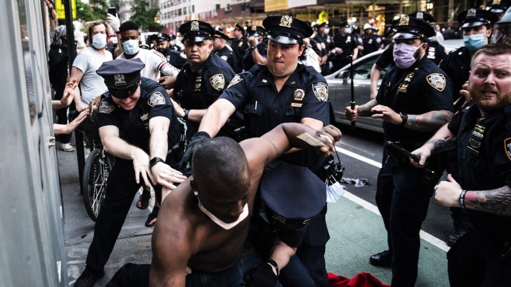 Protestor struggling to get away from cops