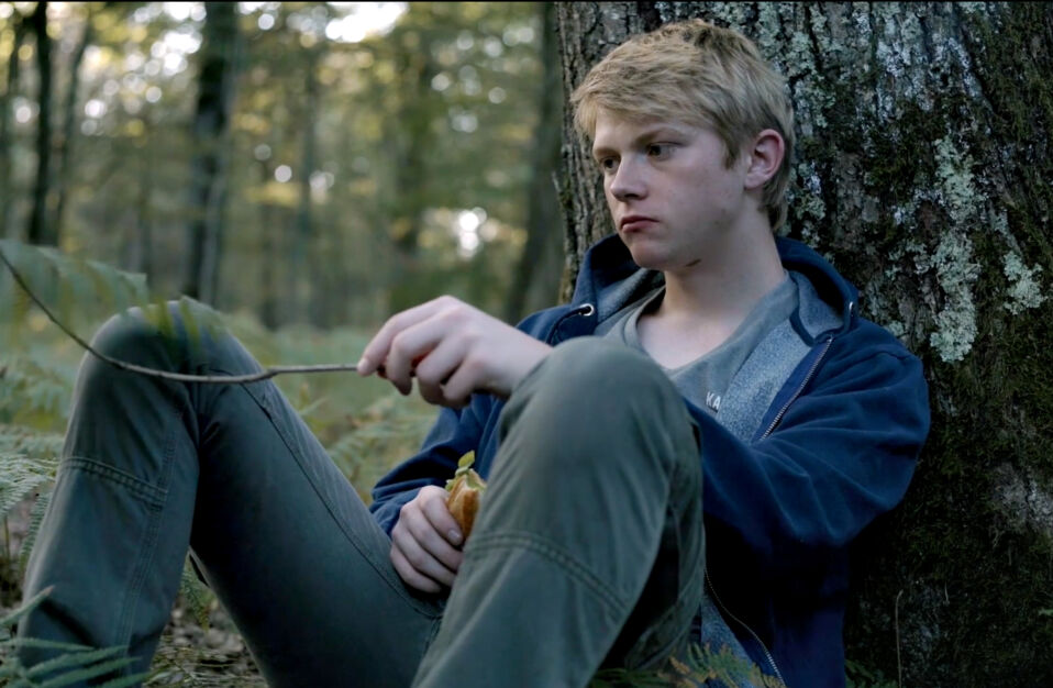 Gabriel sitting in the woods