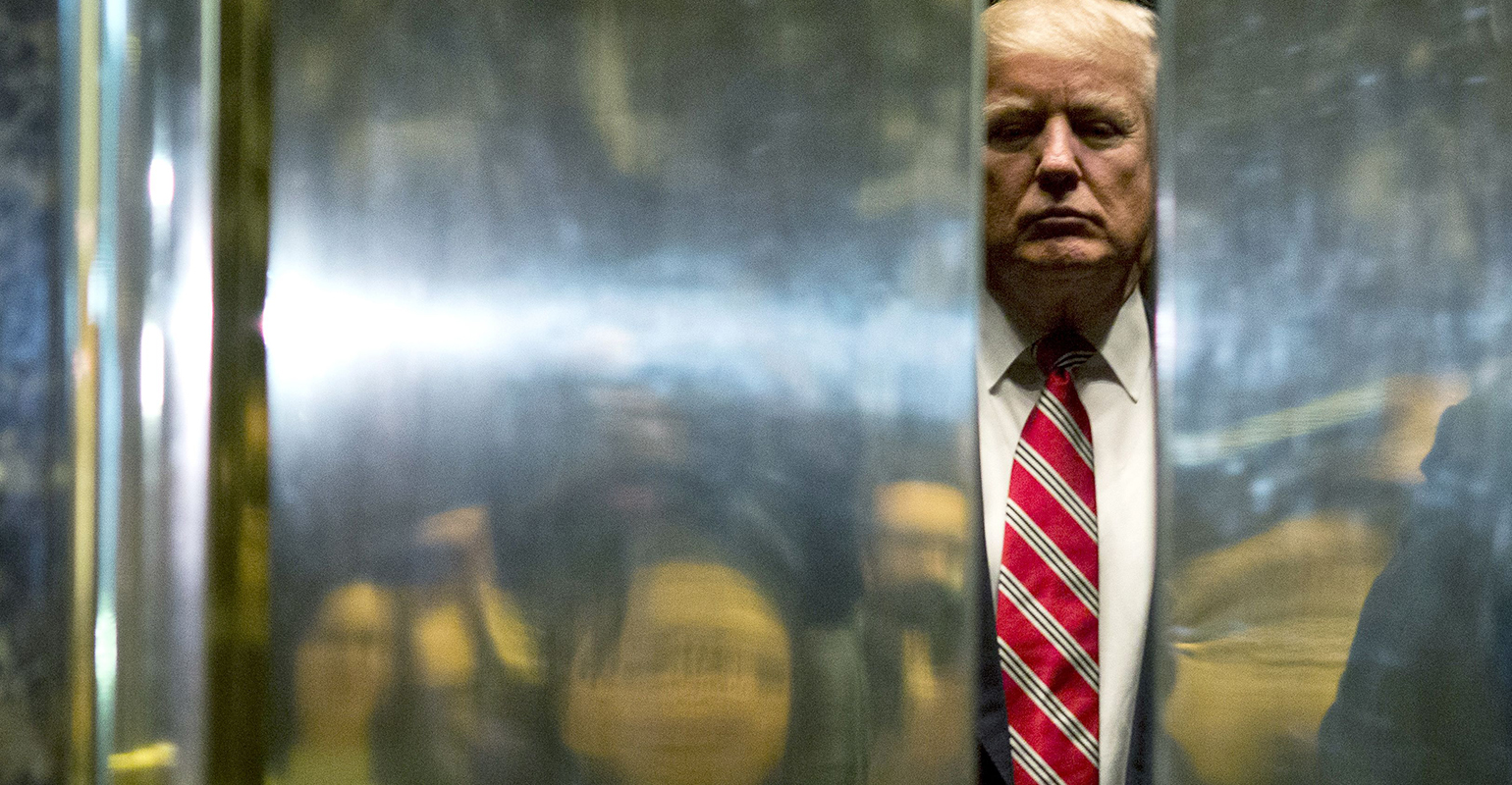 US President-elect Donald Trump boards the elevator after escorting Martin Luther King III to the lobby after meetings at Trump Tower in New York City on January 16, 2017. / AFP / DOMINICK REUTER (Photo credit should read DOMINICK REUTER/AFP via Getty Images)