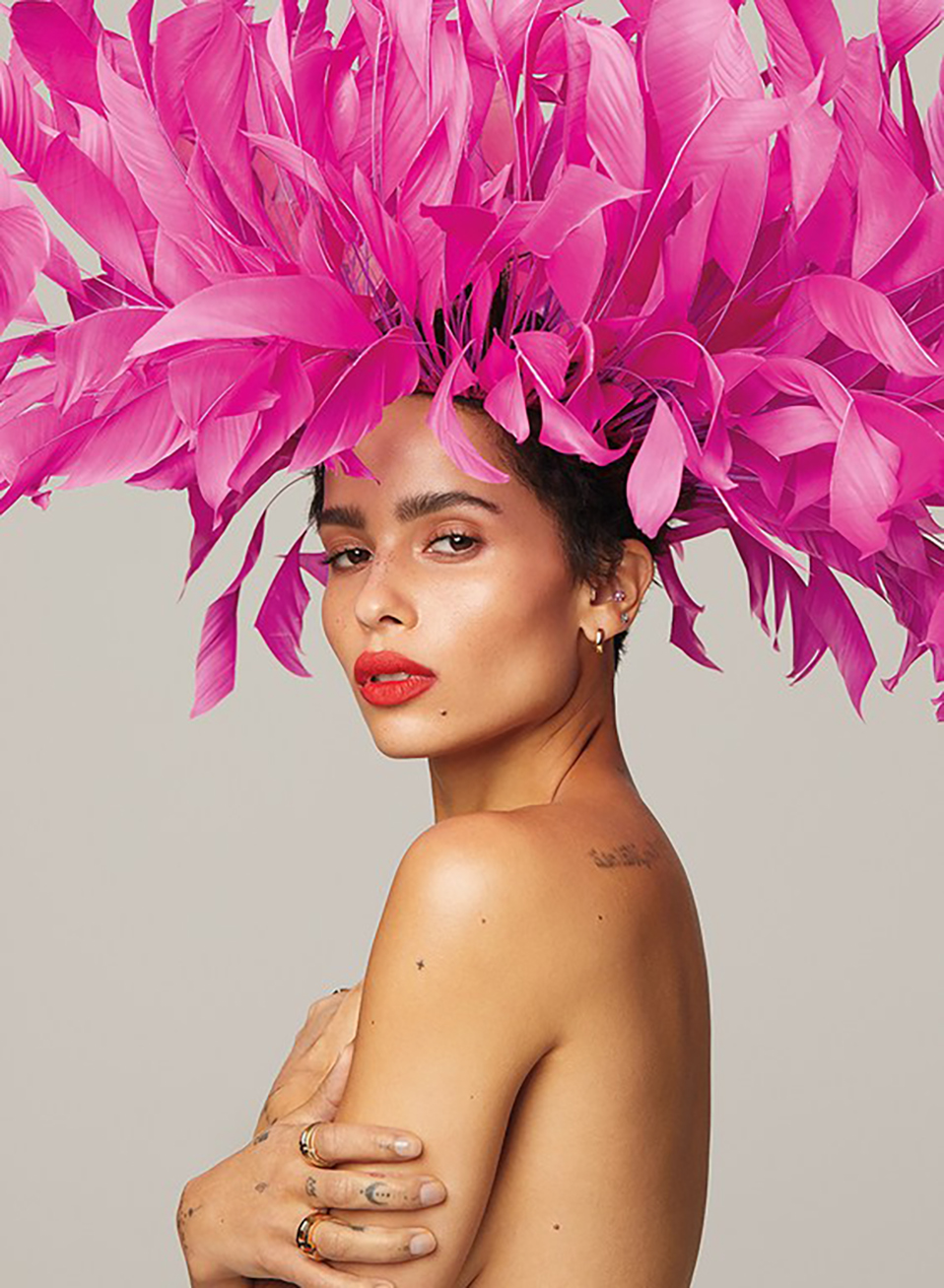zoe kravitz portrait with pink feathers in her hair