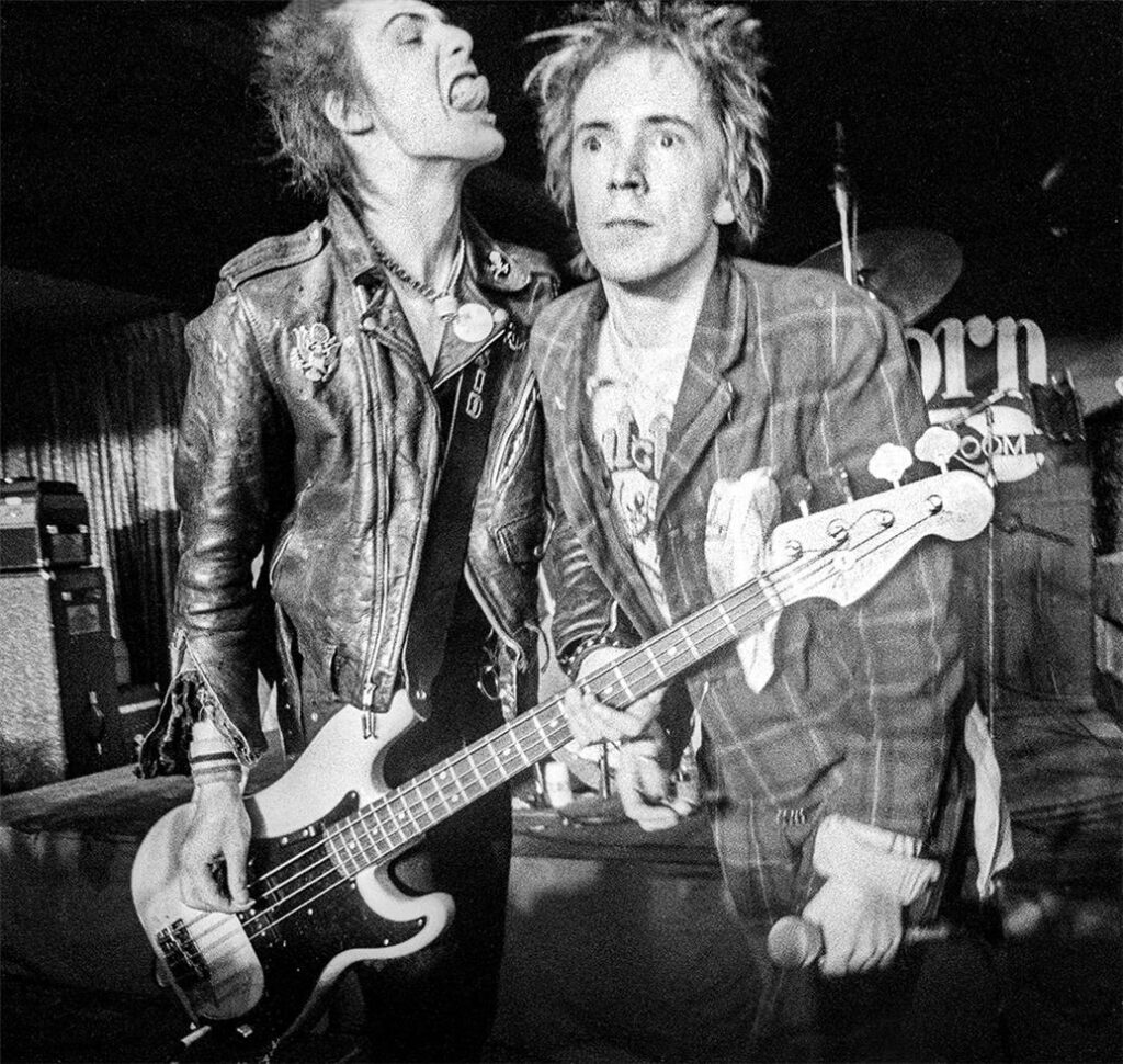 Johnny Rotten Sticking out his tongue and Sid Vicious on Stage