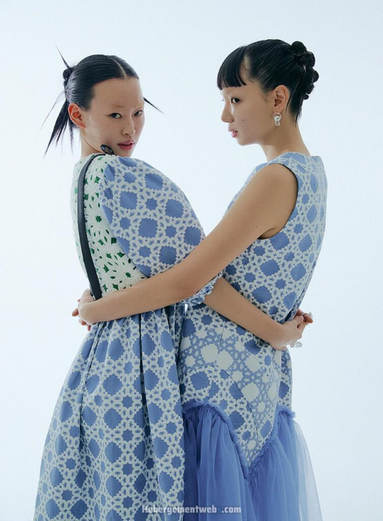 Minju-Kim-Tow-Models-Wearing-Similar-Dress-Pattern-Holding-Eachother-in-an-Embrase