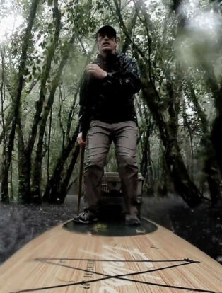 Scientist on Paddle board in the Florida swamp in Chasing Ghosts
