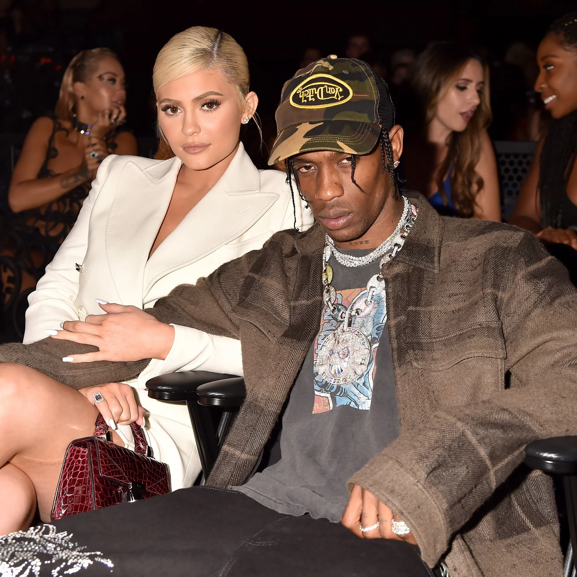 ravis Scott wearing Von Dutch Trucker Cap with Kylie Jenner in a White Suit