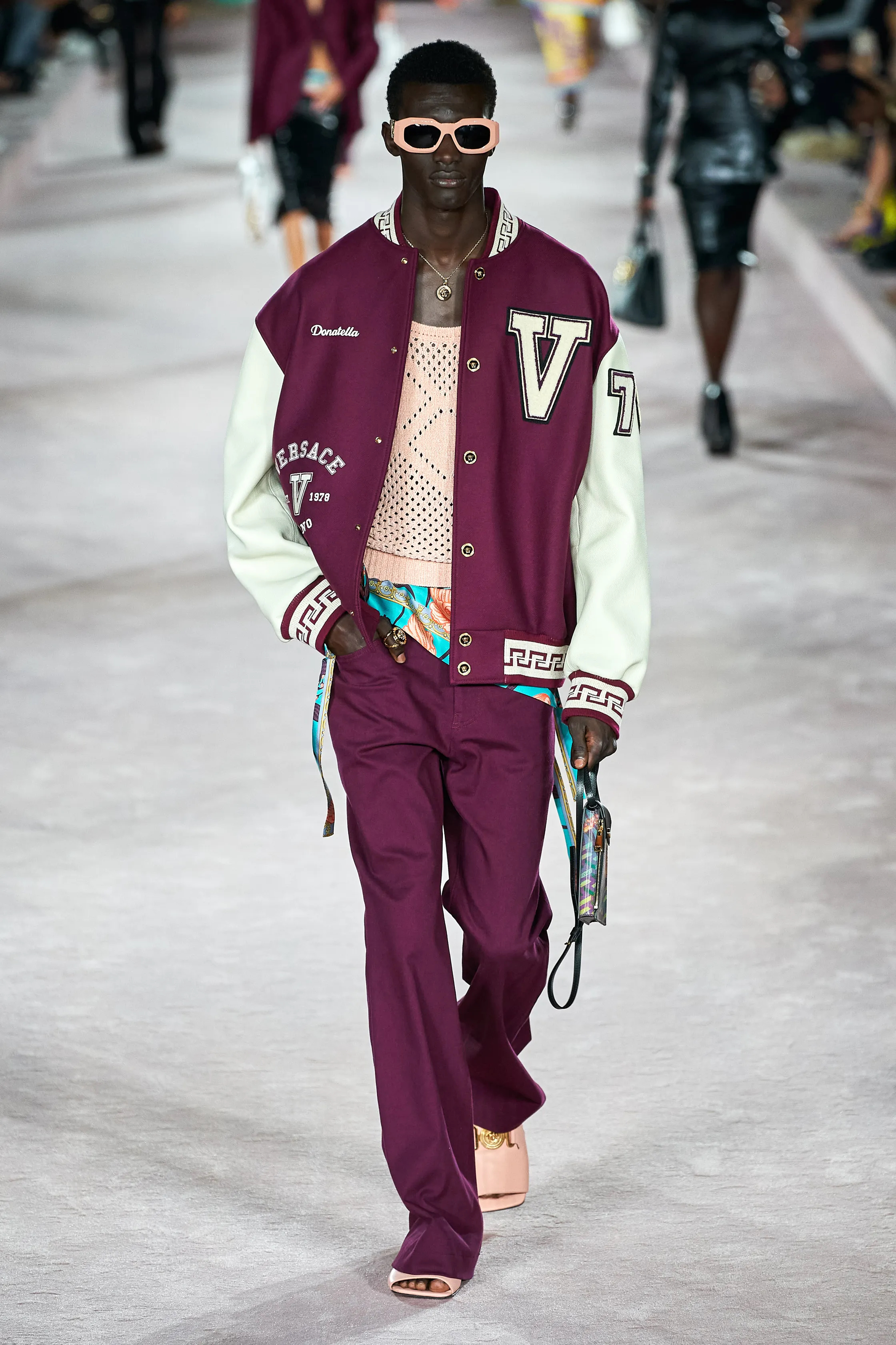 VERSACE RUNWAY SS22 MODEL WEARING A DONATELLA V ATHLETIC JACKET