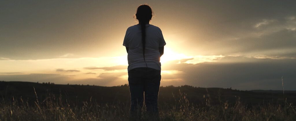 A Dakota Native American View of Woman Wearing a Braid Facing Sundown