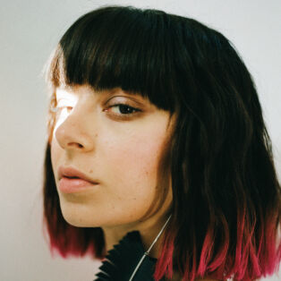 CHARLI XCX side profile with light shining on her left eye