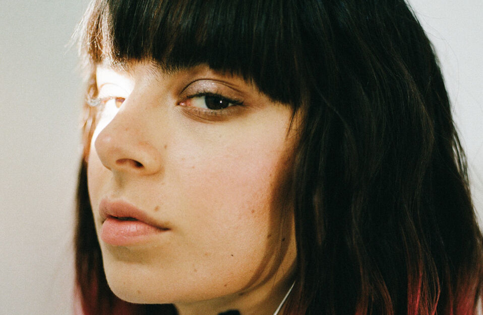 CHARLI XCX side profile with light shining on her left eye