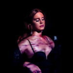 Lana Del Rey Lit With Purple Tint and Shadows
