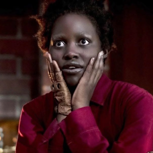 Lupita Nyongo with hands on her face in Us