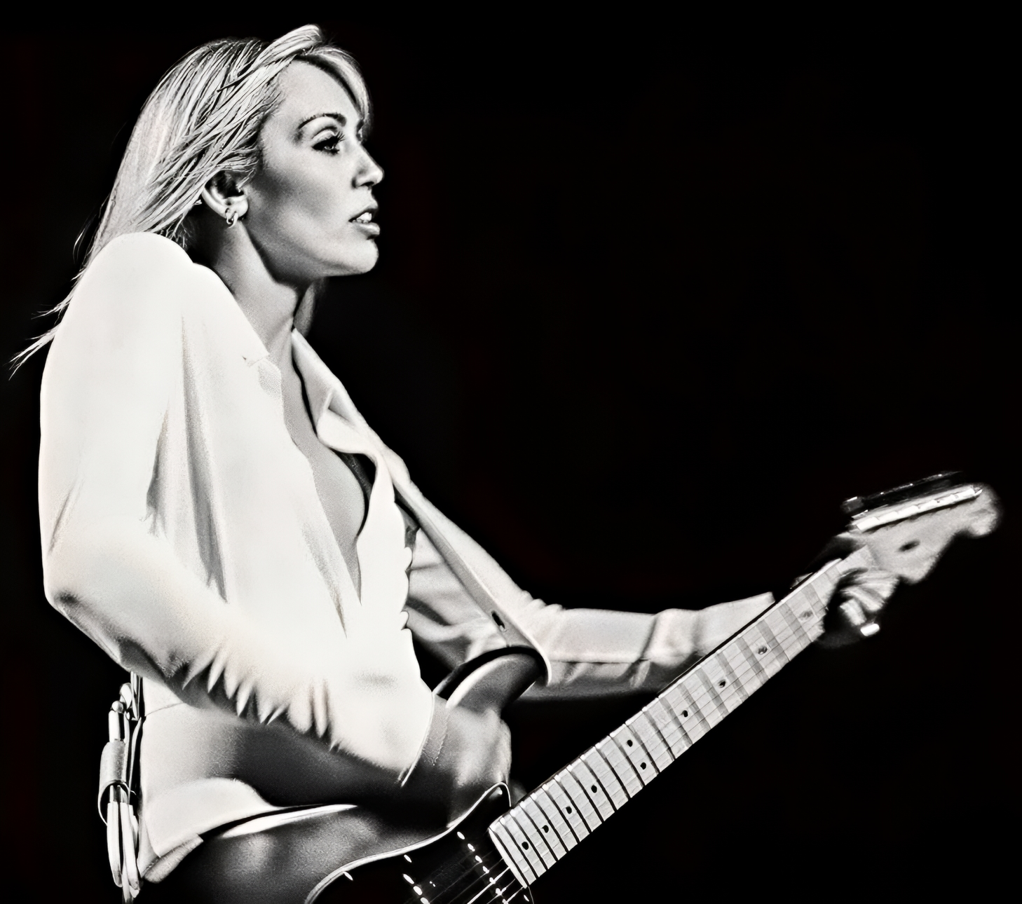 Miley playing electric guitar
